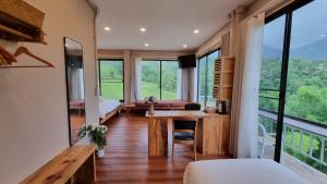 a bedroom with a desk and a room with windows at Piney Stay ไพนี่สเตย์ เขาค้อ in Campson +37 photos