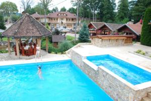 a person in the water in a swimming pool at Balkis Resort in Bakinci