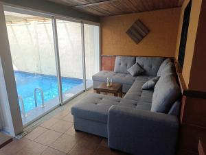 a living room with a couch and a swimming pool at VILLA ELISABETH Piscina y Terraza con Aire Acondicionado in Arriate