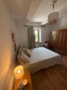 a small bedroom with a bed and a window at La curva del Serpente in Abbadia San Salvatore