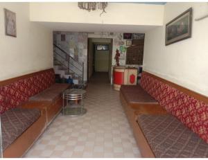 a empty waiting room with benches and a staircase at Hotel Viren Sofitel, Agra in Agra
