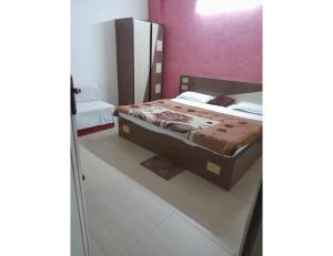a bedroom with a bed and a mirror at Hotel Viren Sofitel, Agra in Agra