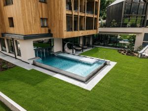 an external view of a building with a swimming pool at Erlebnisort Gassenhof in Ridanna