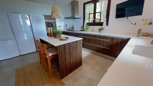 a kitchen with a island in the middle of a kitchen at Drago Luxury Villa in Tarragona