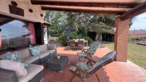 a patio with a couch and chairs and a table at Drago Luxury Villa in Tarragona