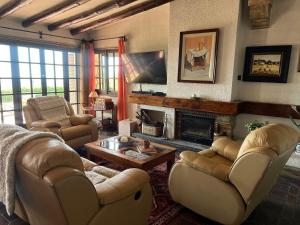 a living room with two couches and a fireplace at Drago Luxury Villa in Tarragona