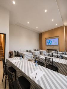 a conference room with tables and chairs and a screen at Meson de la Merced in Zacatecas