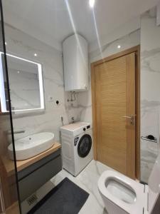a bathroom with a toilet sink and a washing machine at Zlatibor 1 Balkan Square in Zlatibor +49 photos