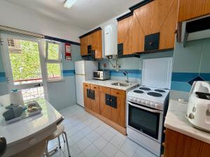 a small kitchen with a stove and a sink at Edificio Fragata A in Armação de Pêra
