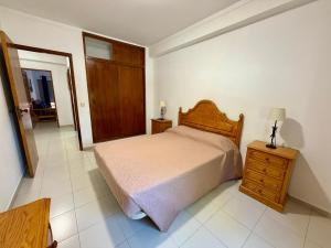 a bedroom with a bed and a dresser and a door at Edificio Fragata A in Armação de Pêra +11 photos