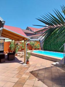 a backyard with a swimming pool and a pavilion at Apartmán u Šmídů in Jaroslavice