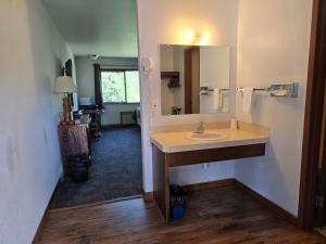 a bathroom with a sink and a mirror at Rimrock Lodge LLC in Thompson Falls +36 photos