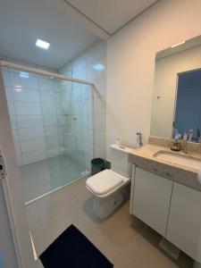 a bathroom with a toilet and a glass shower at Flamboyant Stay Rooms in Goiânia +15 photos