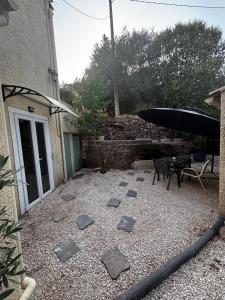 a patio with rocks on the ground next to a building at La Cigalière 2 charmant T2 avec terrasse dans villa in Solliès-Ville