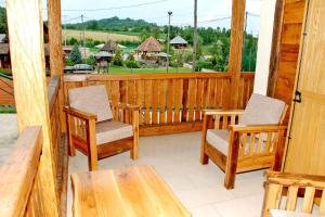 a porch with chairs and a table and a view at Balkis Resort in Bakinci