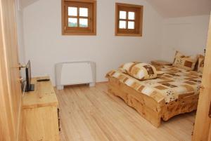 a bedroom with a wooden bed and a desk at Balkis Resort in Bakinci