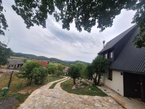 an external view of a house with a stone driveway at Kuća za odmor - Villa Magdalena in Otočac