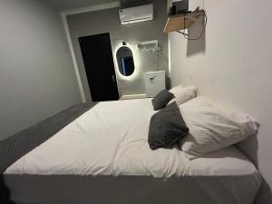 a bedroom with a bed with two pillows on it at Suite Brisa da Colina in Garanhuns +5 photos