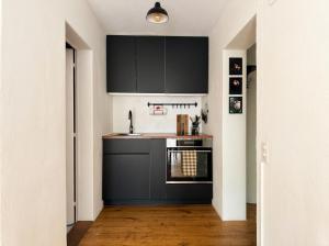 a kitchen with a sink and a stove at Boutique Garden Studio in Kreuzlingen