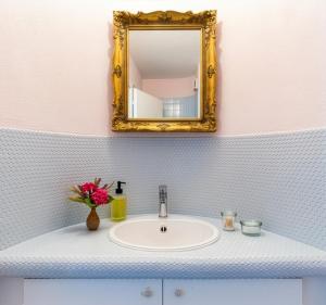 a bathroom with a sink and a mirror at Boutique Garden Studio in Kreuzlingen