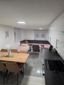 a living room with a couch and a table at Apartman Ventus in Bihać +10 photos