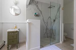 a shower with a glass door in a bathroom at The Woodbine Inn in Palenville +53 photos
