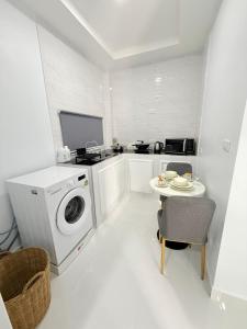 a white laundry room with a washing machine and a table at Hana residence Bangtao BeachBangtao 11 Phuket in Ban Thalat Choeng Thale +34 photos