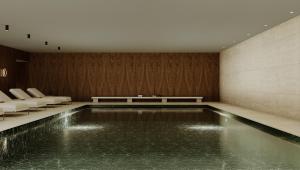 a pool of water in a room with chairs at Grand Hotel Açores Atlântico in Ponta Delgada