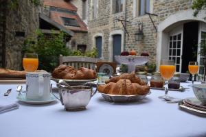 a table with a white table cloth with bread and orange juice at Le relais de saint Jacques in Boulogne-sur-Mer +11 photos