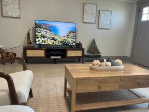 a living room with a tv and a coffee table at Alki Beach Nest in Seattle