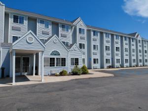 a large white building with a lot of windows at Microtel Inn & Suites by Wyndham Holland in Holland