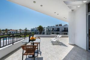 a patio with a table and chairs on a balcony at Stella Maris in Kos