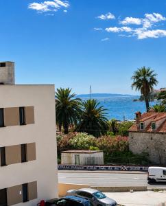 a view of the ocean from a building at Apartments & Rooms Prižmić in Podstrana