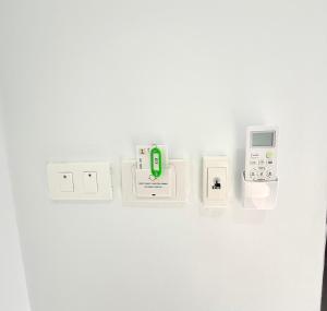 a wall with several electronic devices on it at Hana residence Bangtao BeachBangtao 11 Phuket in Ban Thalat Choeng Thale