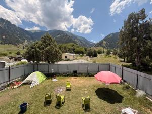 a tent and some chairs and a red umbrella at Hotel GRITTI CASTLE in Wāmpor
