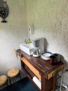 a counter with a coffee maker and a mixer on it at Britania Hobbit in Predeluţ