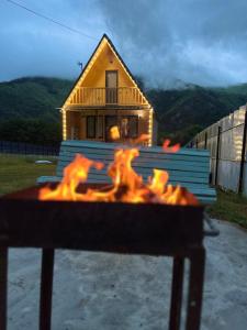a fire pit in front of a house at Pine House Borjomi , Mountain View in Borjomi