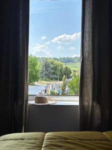 a bedroom window with a view of a street at Cyprès des Vignes- L'Ecrin in Hermonville