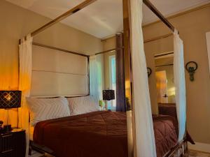 a bedroom with a canopy bed and a window at Master Suite De Carlo Shared Property PRIVATE stay NYC 18mins in North Bergen