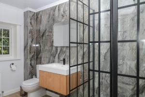 a bathroom with a sink and a stone wall at The White House in Okehampton +63 photos
