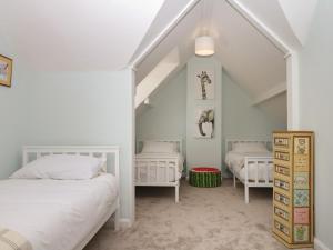 a bedroom with two beds in a attic at The White House in Okehampton