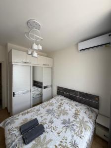 a bedroom with a bed with a black bag on it at Olmazor Comfort in Qoraqamish