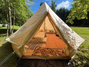 a tent is set up in a field at Lahemaa Nature Glamping - Kuma in Vihasoo