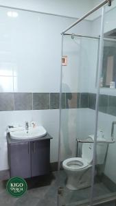 a bathroom with a toilet and a sink at Kigo Perch in Kampala