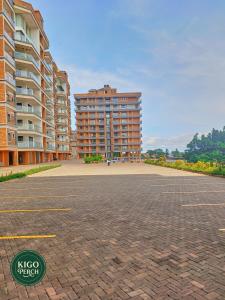 an empty parking lot with two tall buildings at Kigo Perch in Kampala