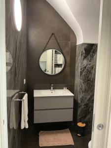 a bathroom with a sink and a mirror at Moira Luxury Appartament in Bitonto +43 photos