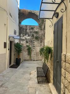 an alley with a ladder and a bench in a building at Moira Luxury Appartament in Bitonto