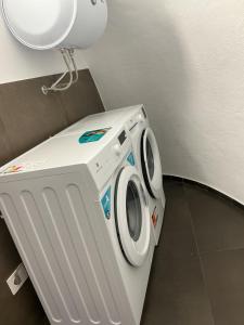 a washing machine in a room with a light at Moira Luxury Appartament in Bitonto