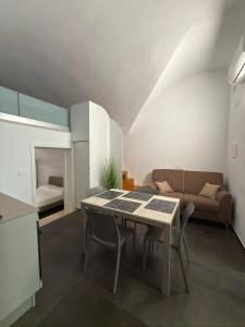 a living room with a table and a couch at Moira Luxury Appartament in Bitonto