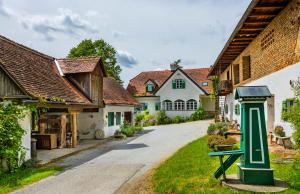 a street in a village with white houses at Hirschenhof in Graz
